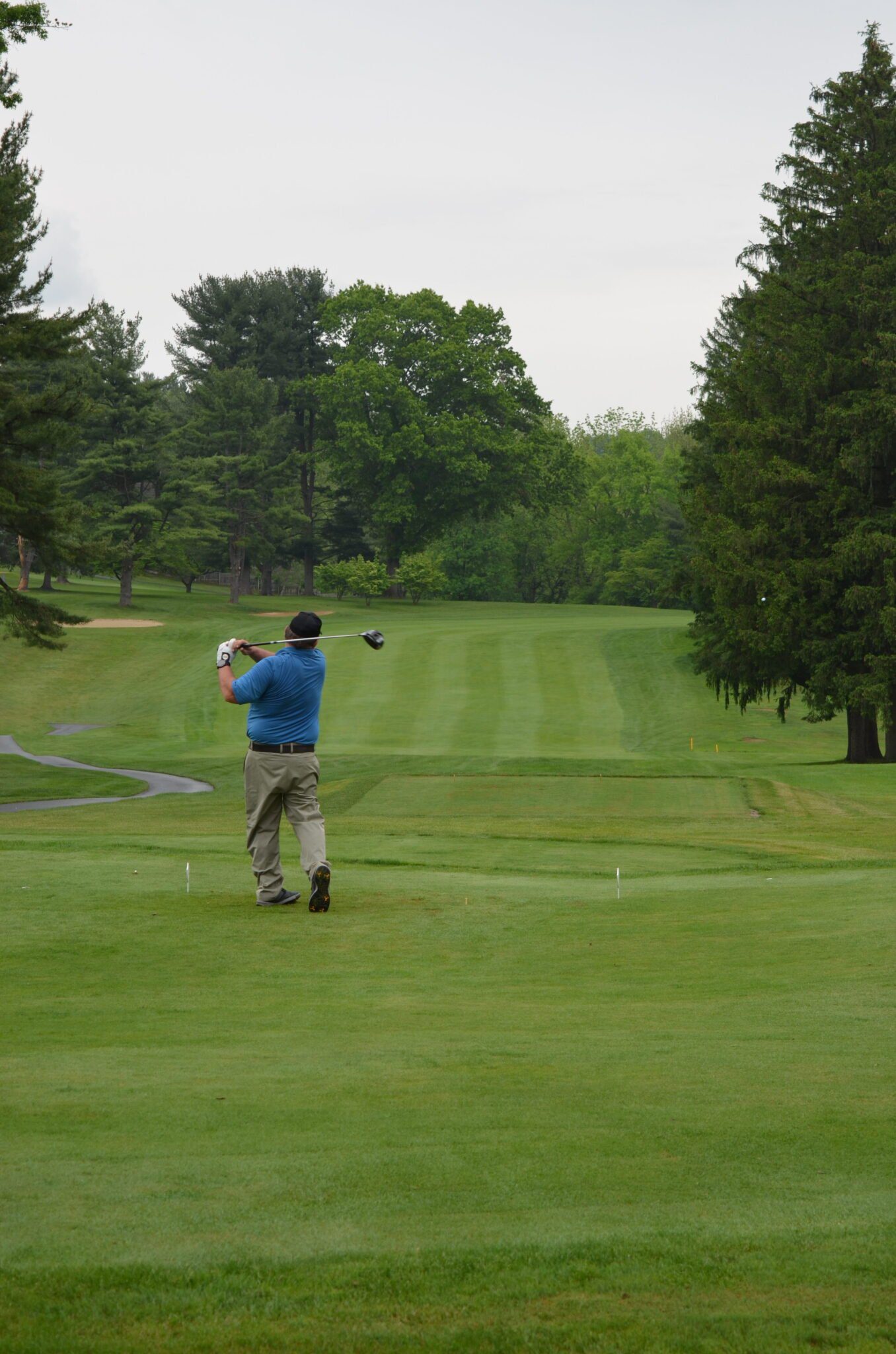 person swinging golf club