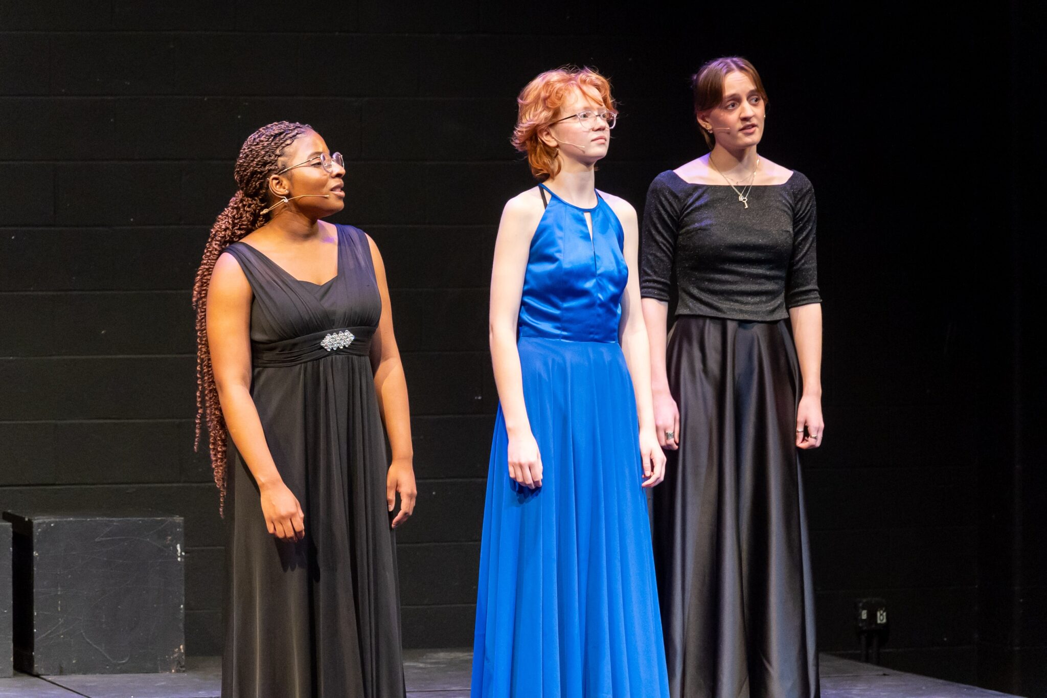 students on stage singing