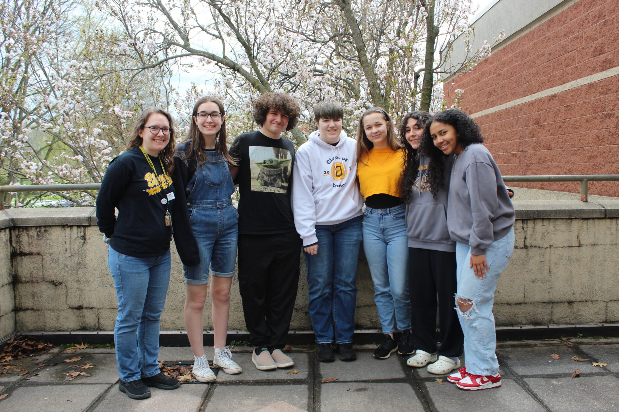 LMH Yearbook staff 2023-24 standing outside of art building