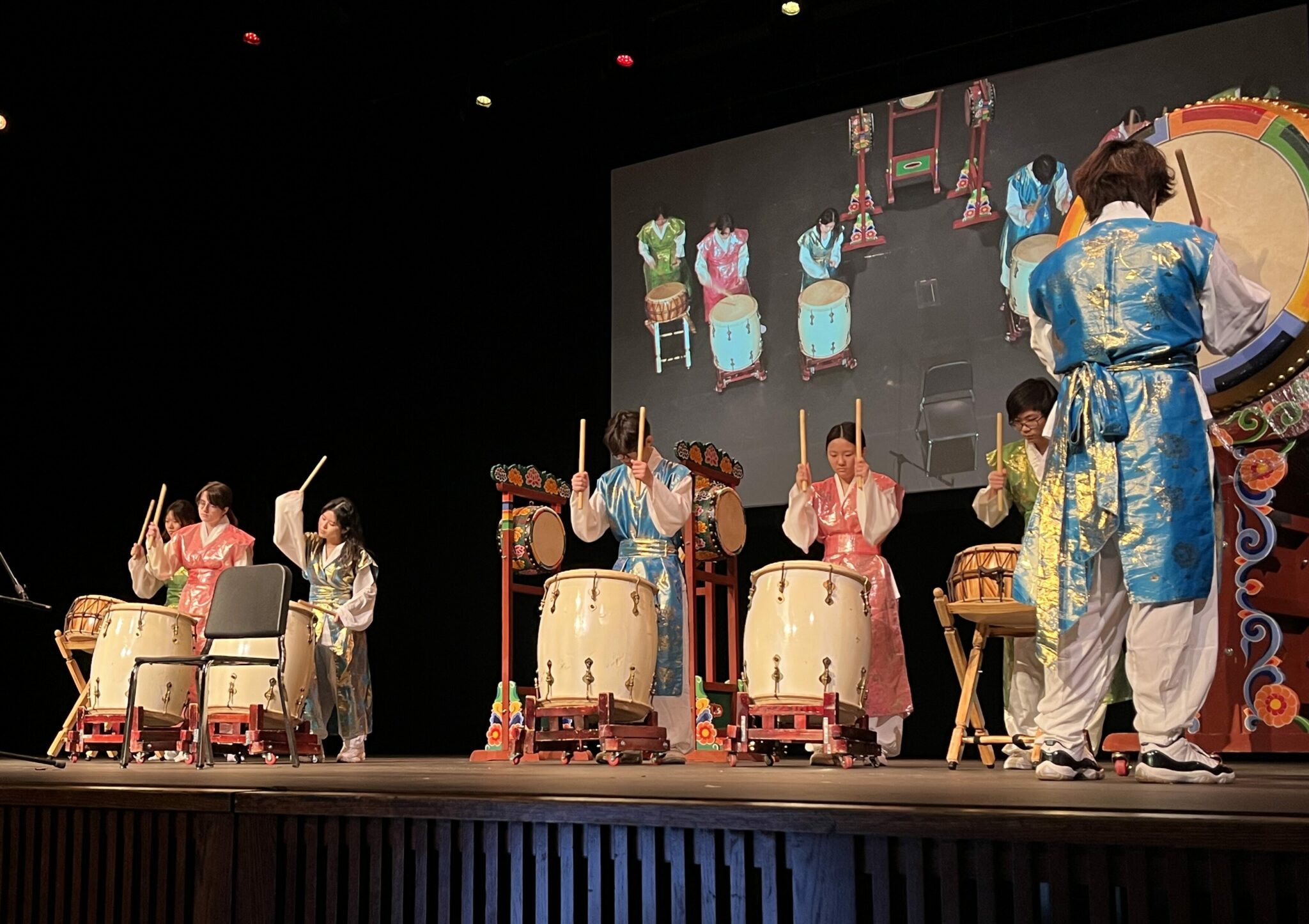 Lunar new year chapel celebration 2024. Selahart south korean music group students perform on drums.