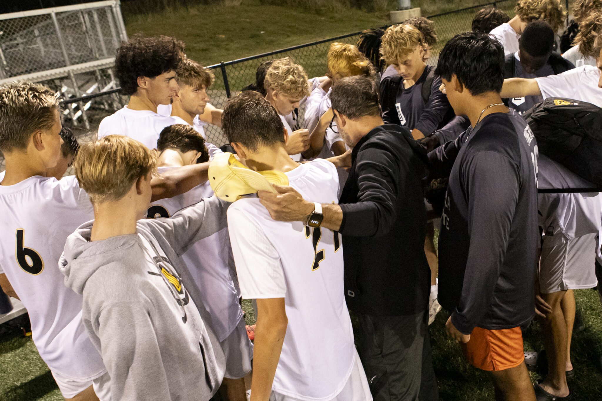 Boys Varsity Soccer Team praying