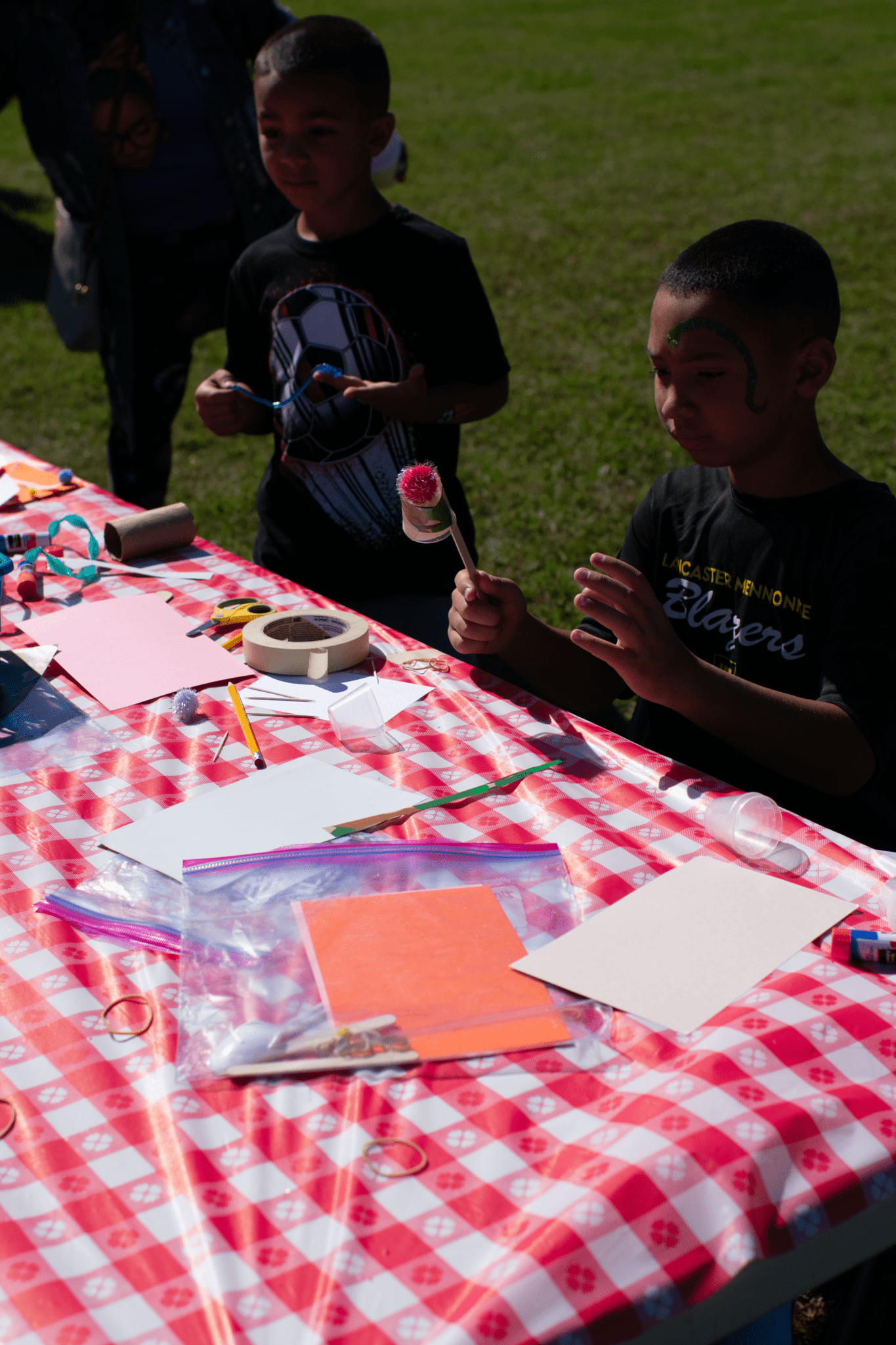 students at the face painting table