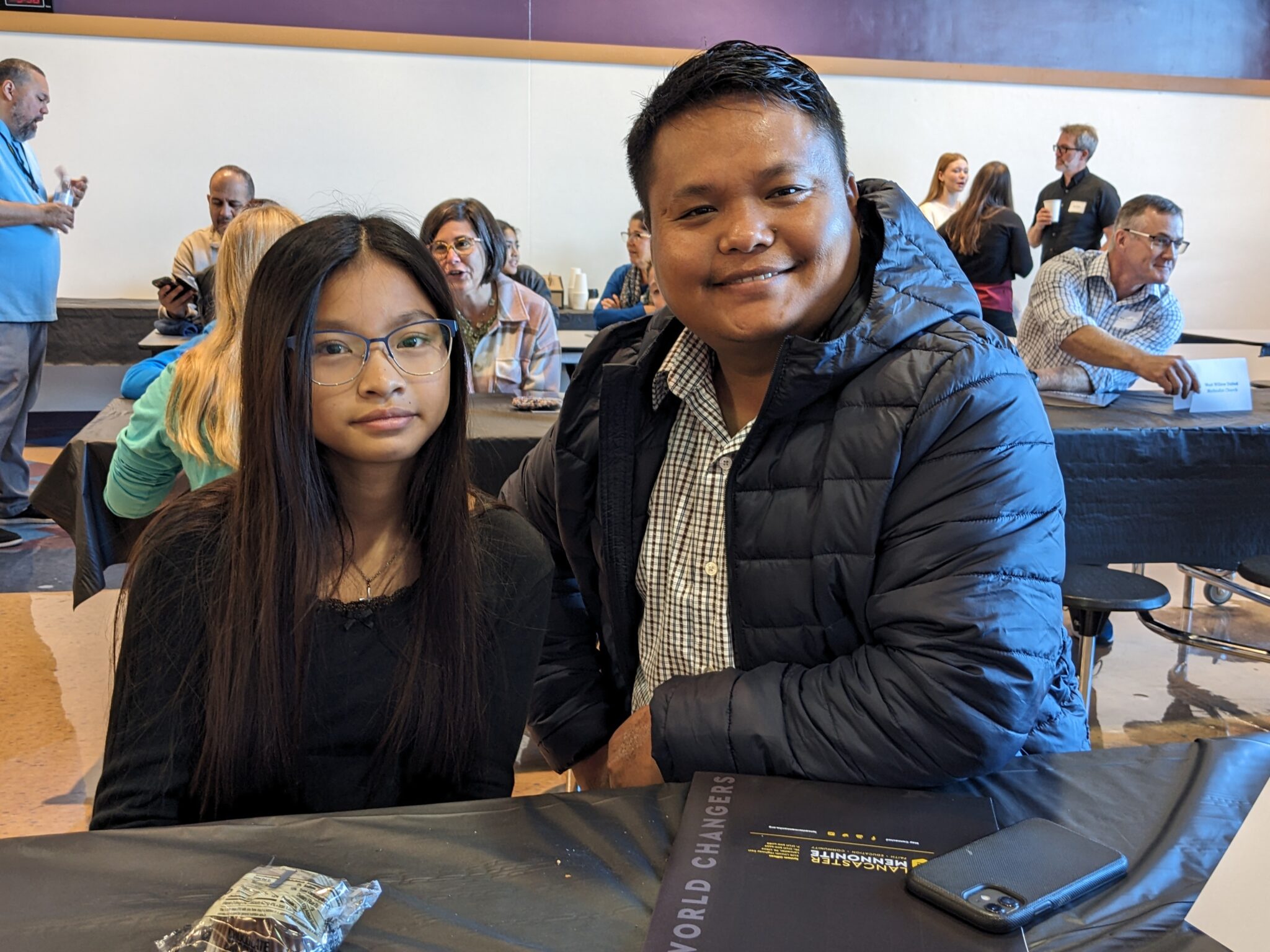 Student with Pastor in cafeteria.