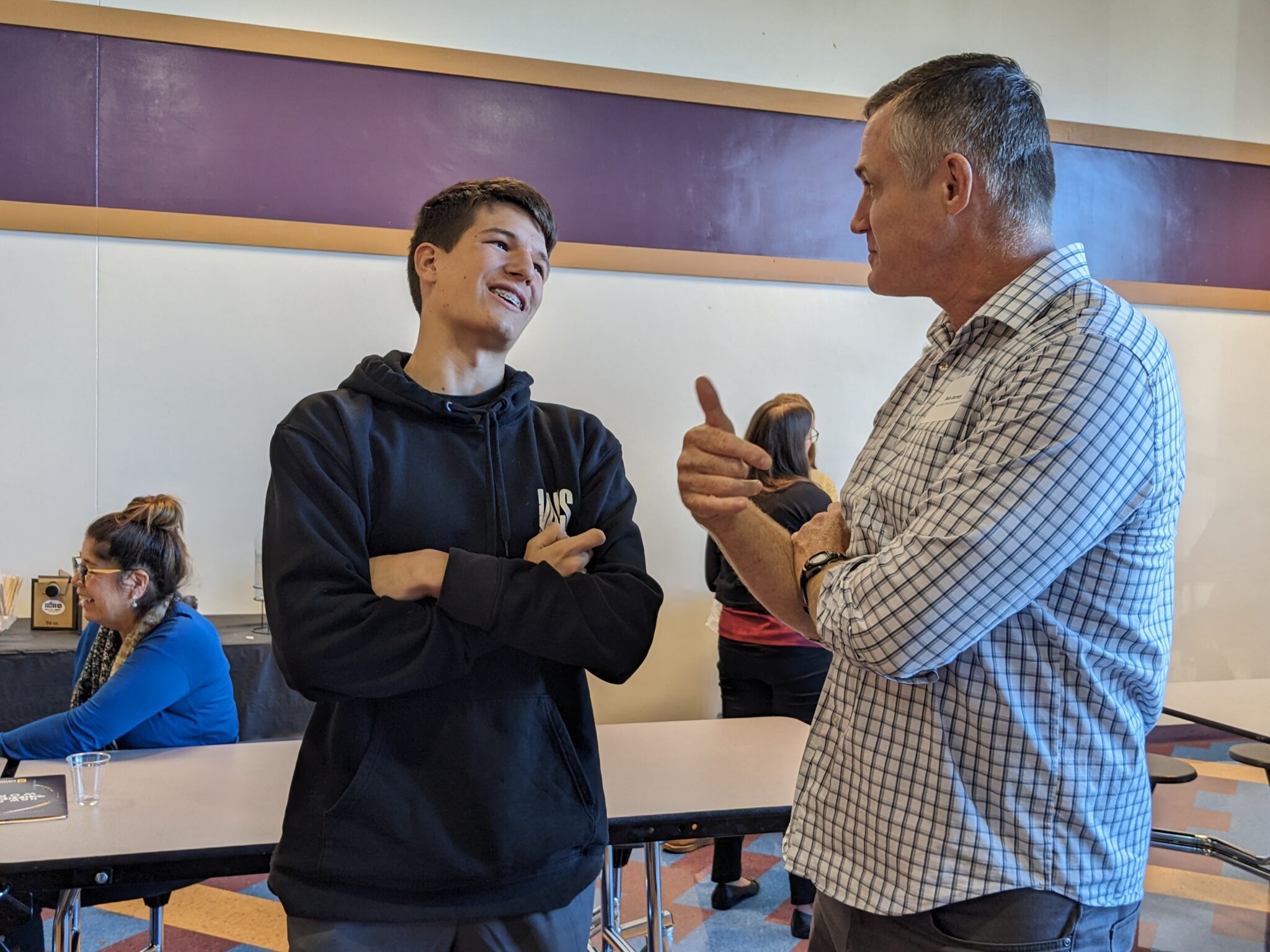 Student with Pastor in cafeteria.