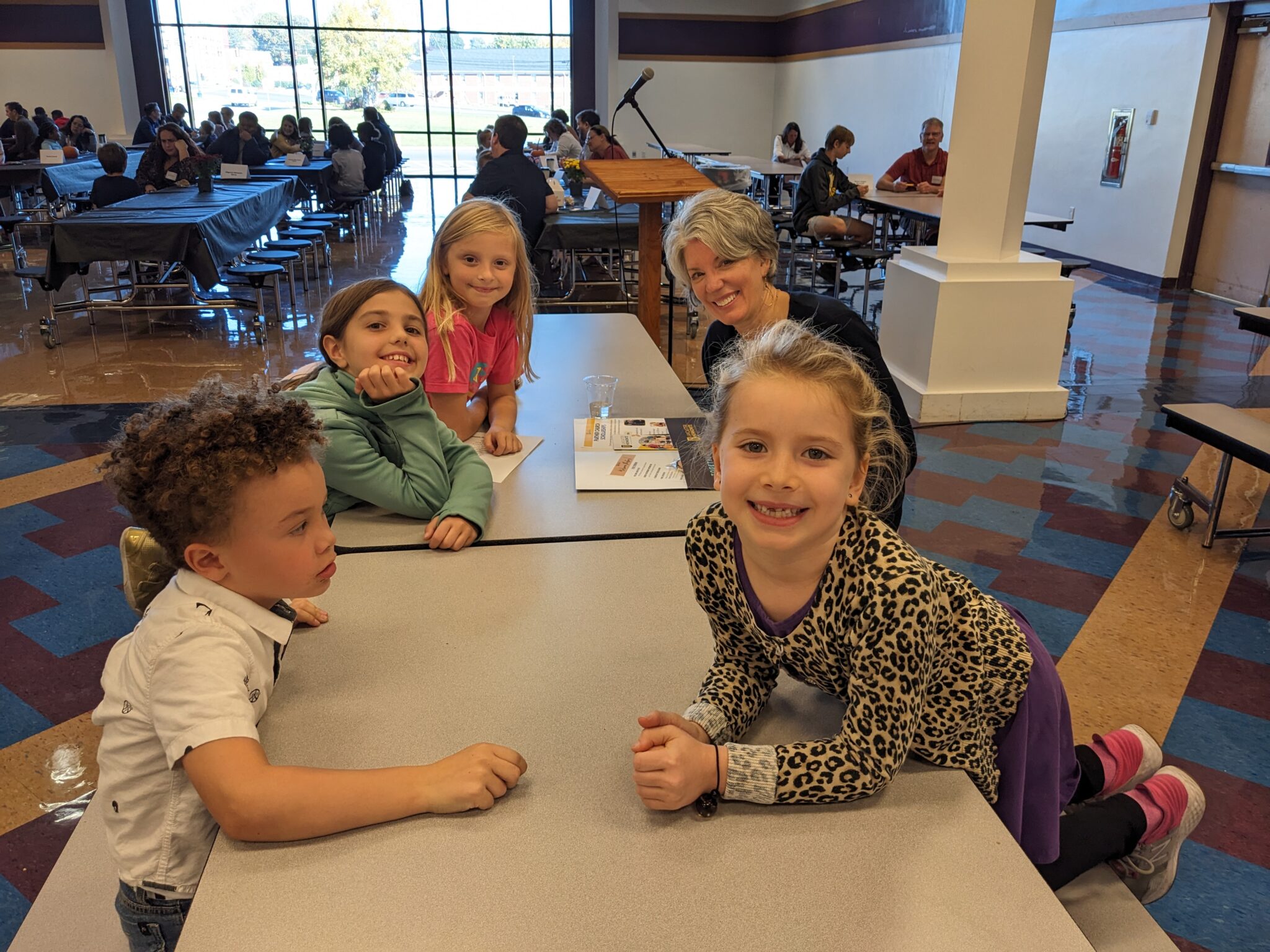 Students with Pastor in cafeteria.