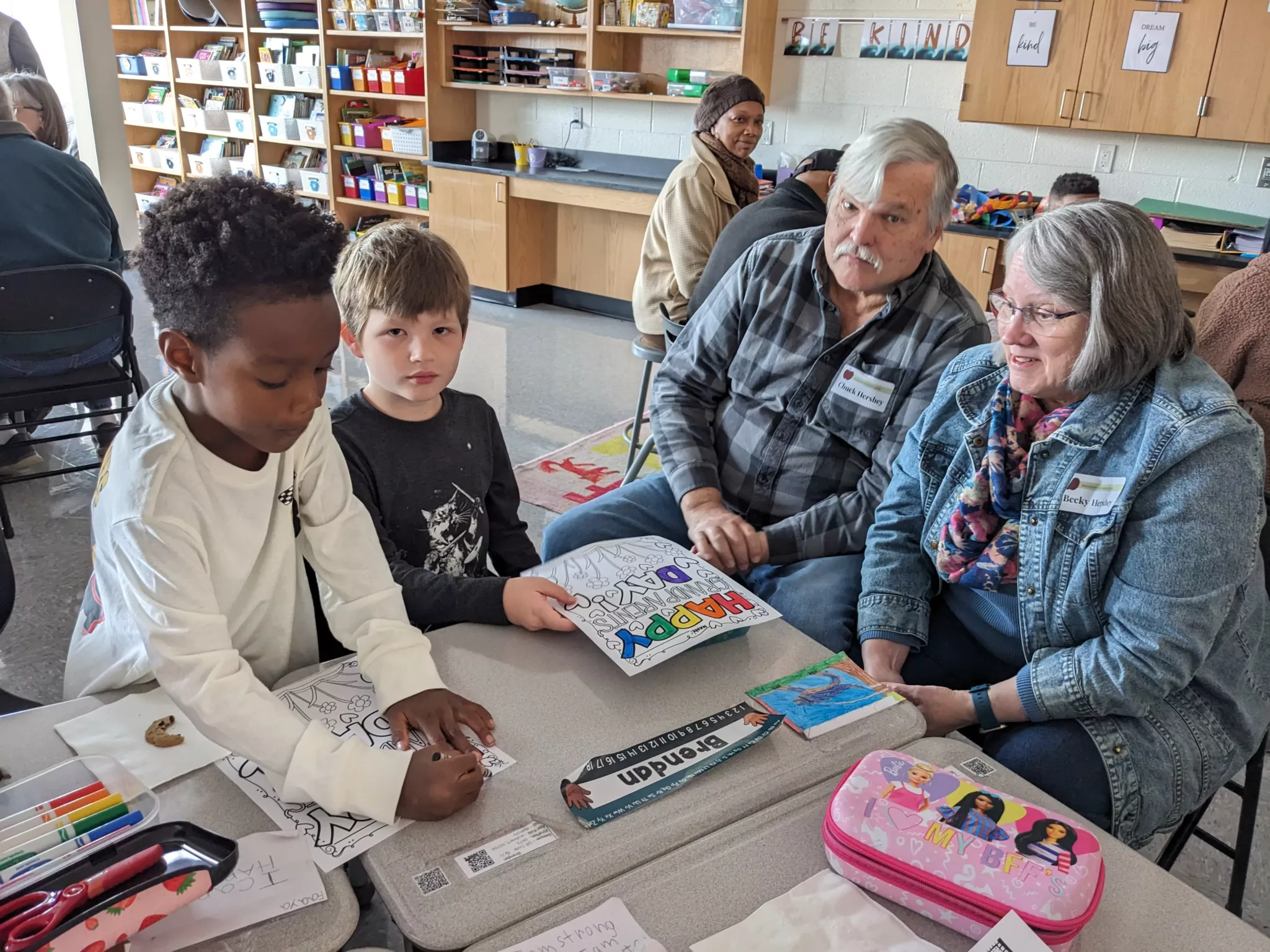 Students with grandparents at Grandparents Day coloring