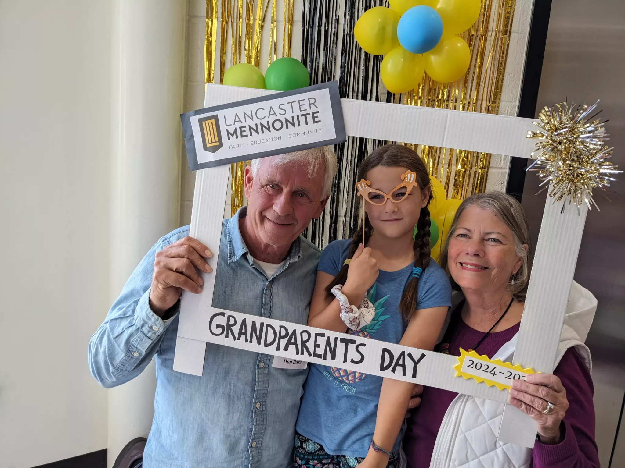 Student with grandparents at Grandparents Day