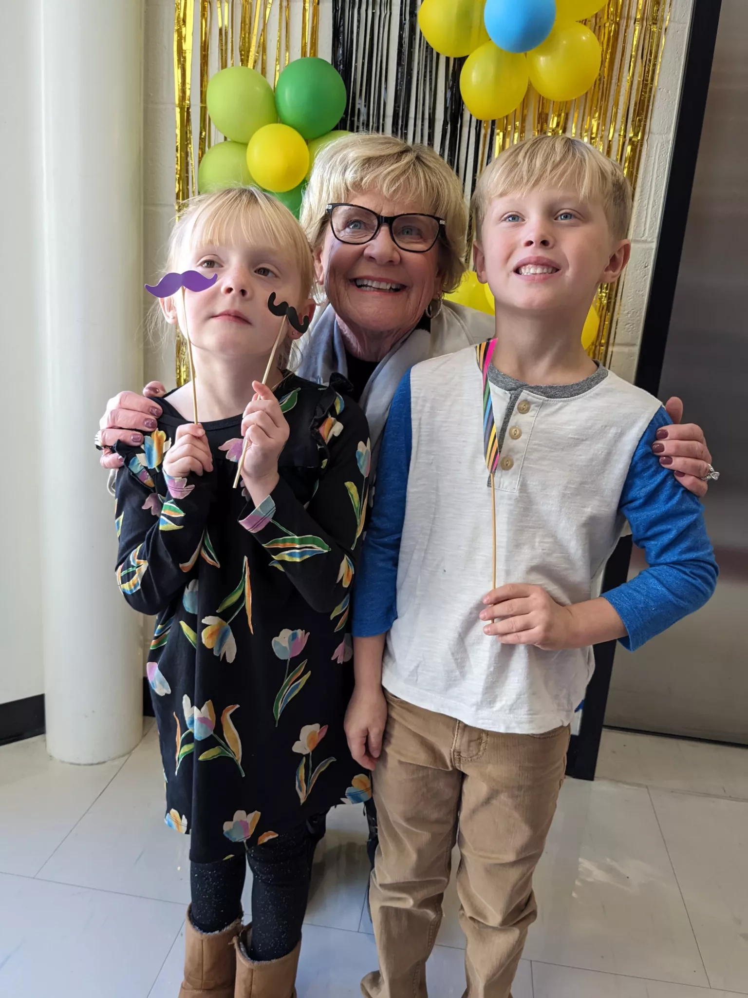 students at photobooth with grandparent