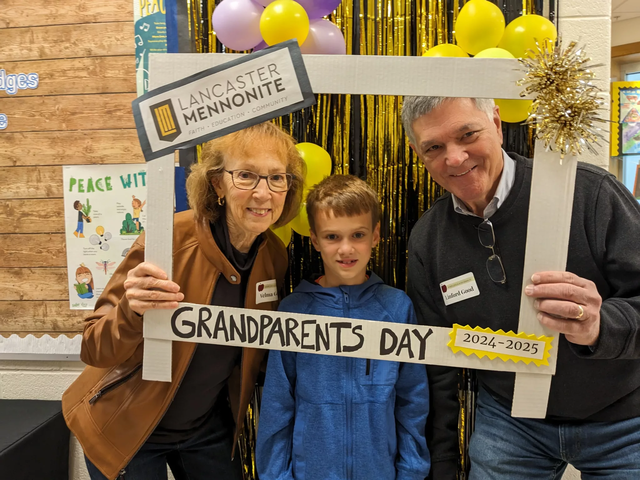 Student with grandparents at Grandparents Day