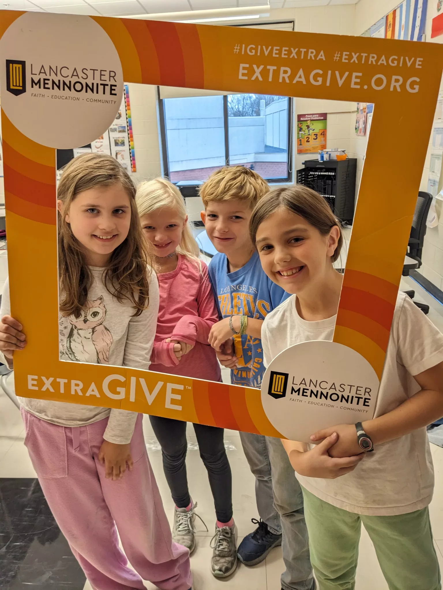 Students with ExtraGive sign