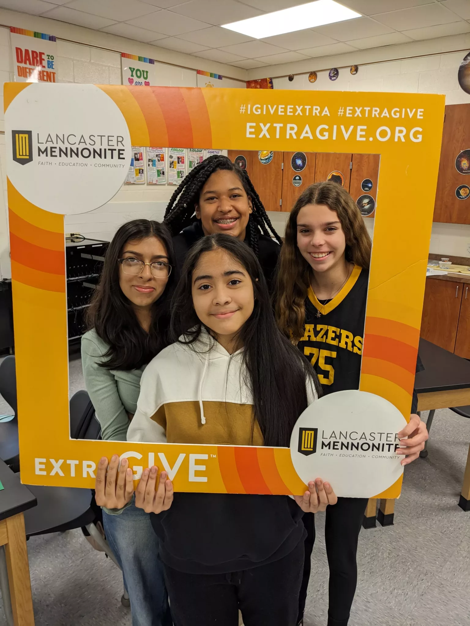 Students with ExtraGive sign
