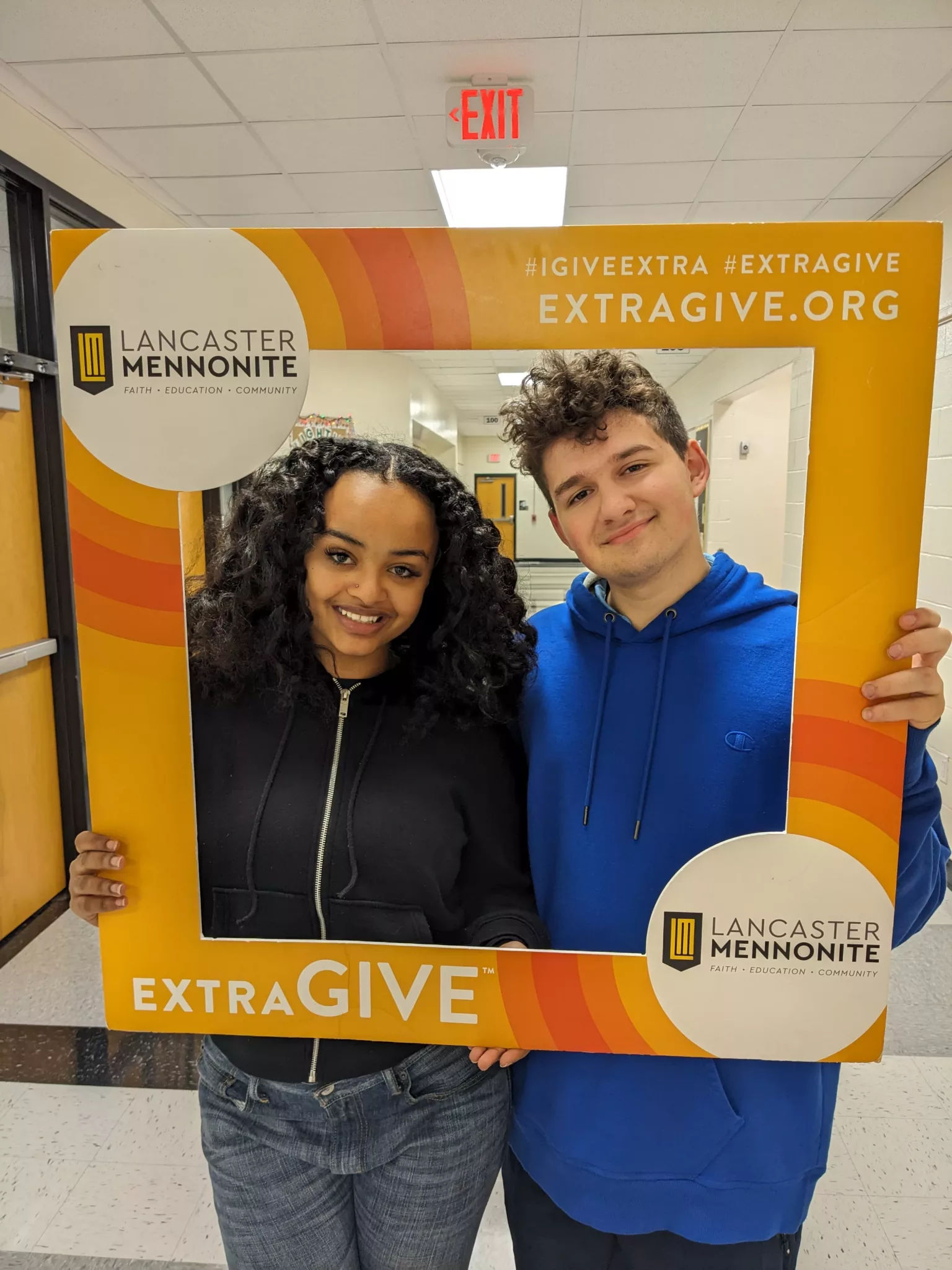 Students with ExtraGive sign