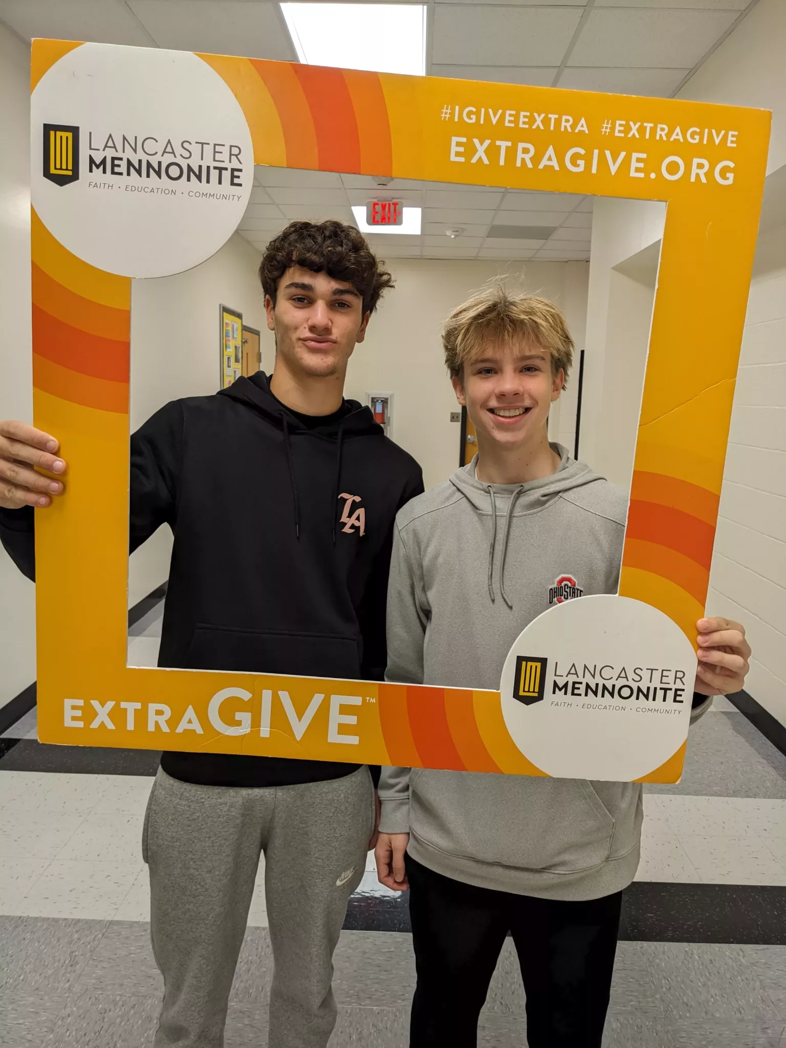 Students with ExtraGive sign