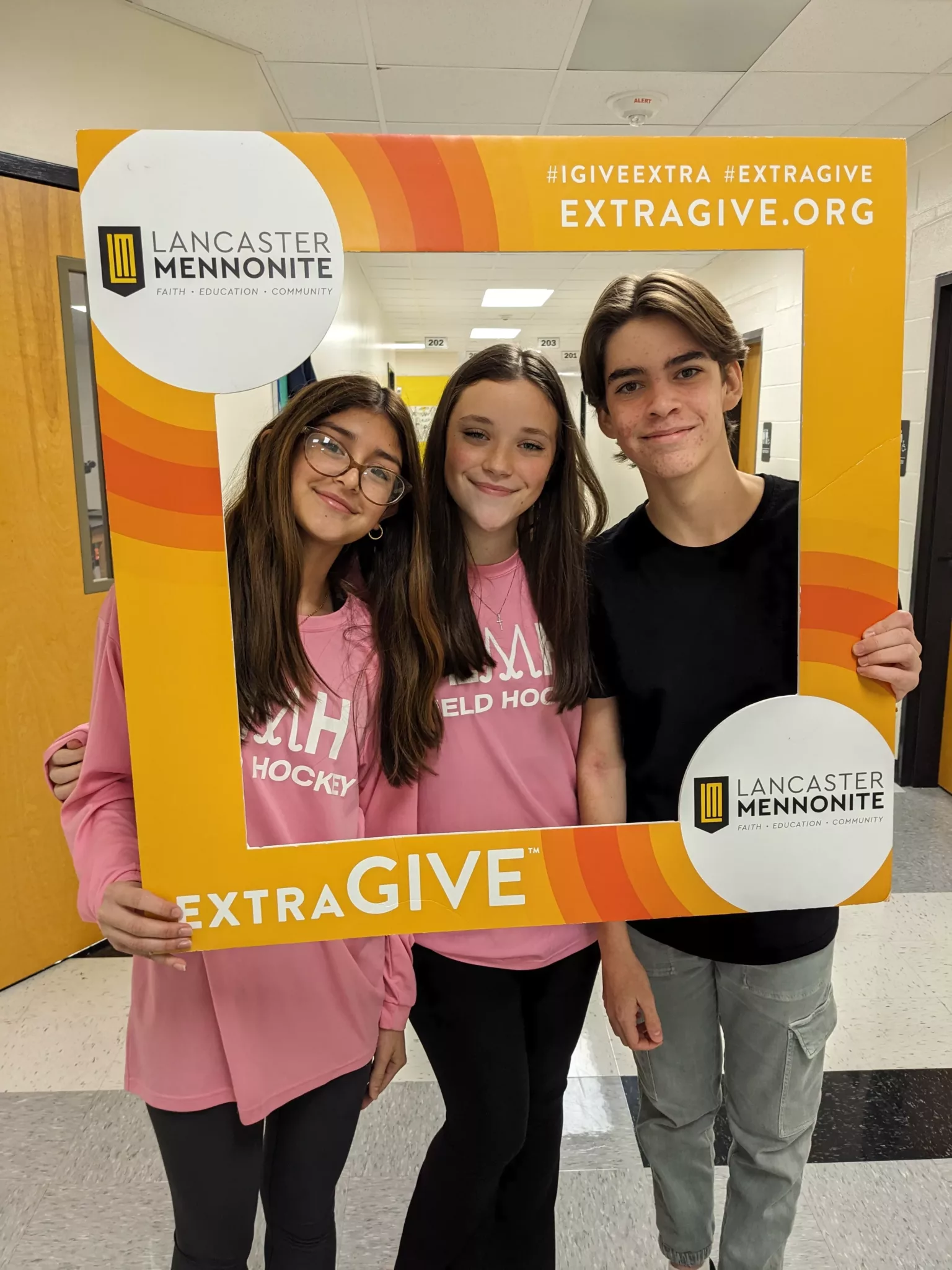 Students with ExtraGive sign