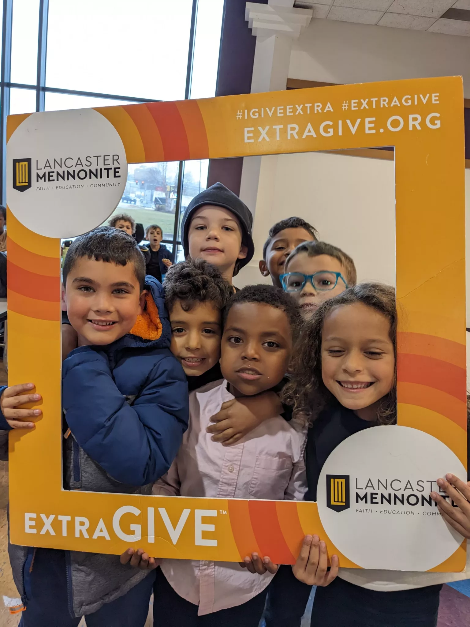 Students with ExtraGive sign