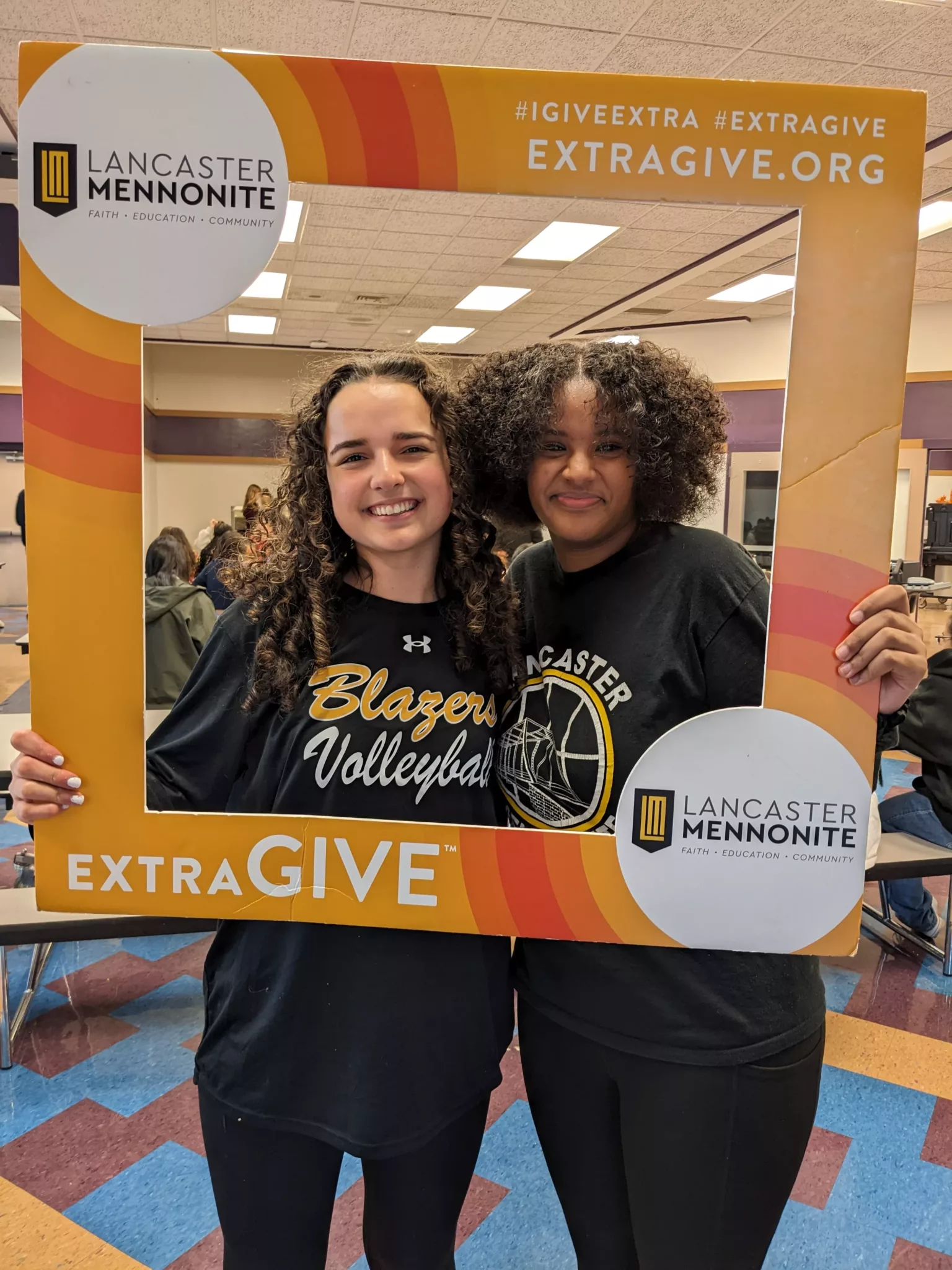 Students with ExtraGive sign