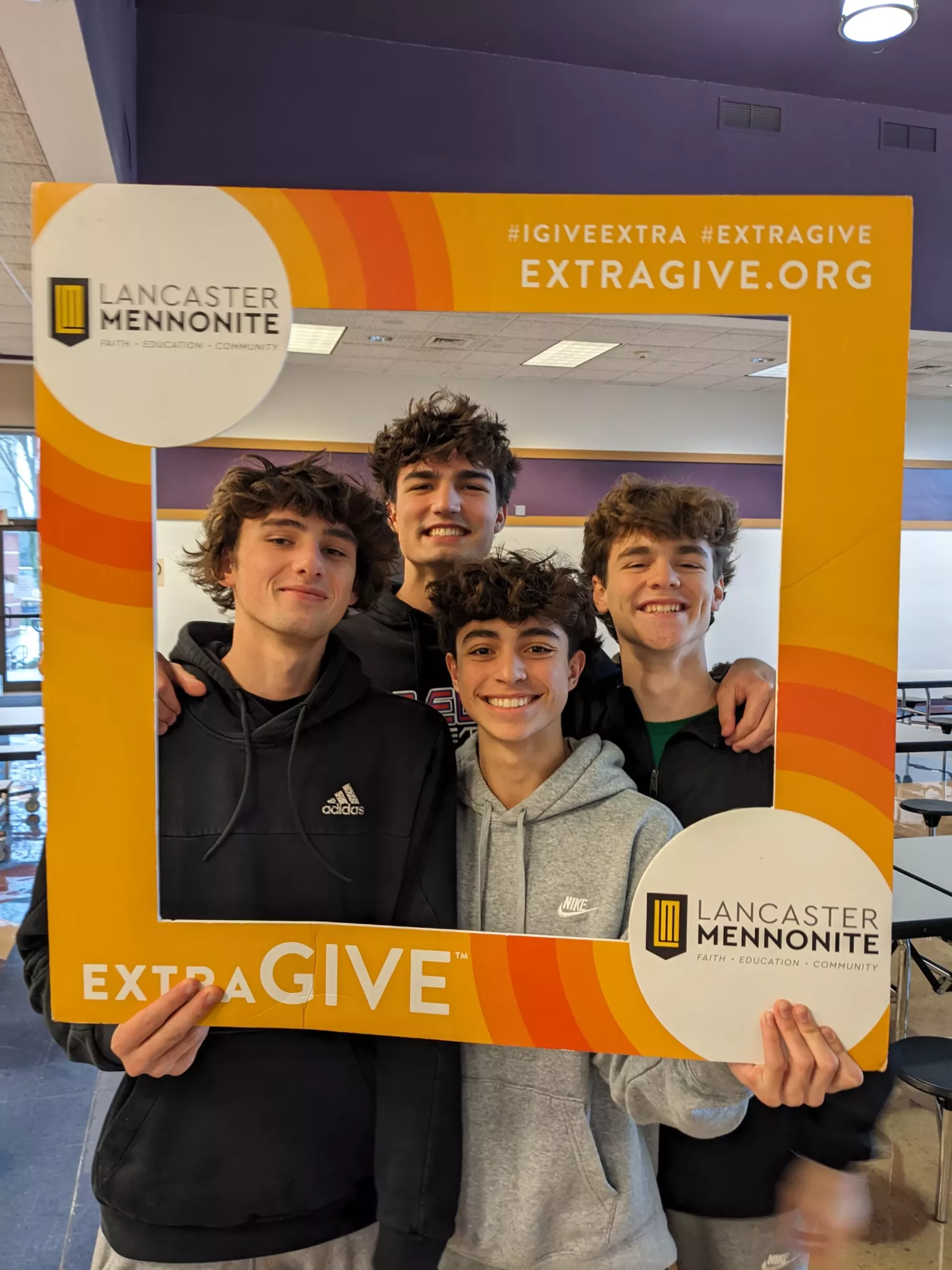 Students with ExtraGive sign
