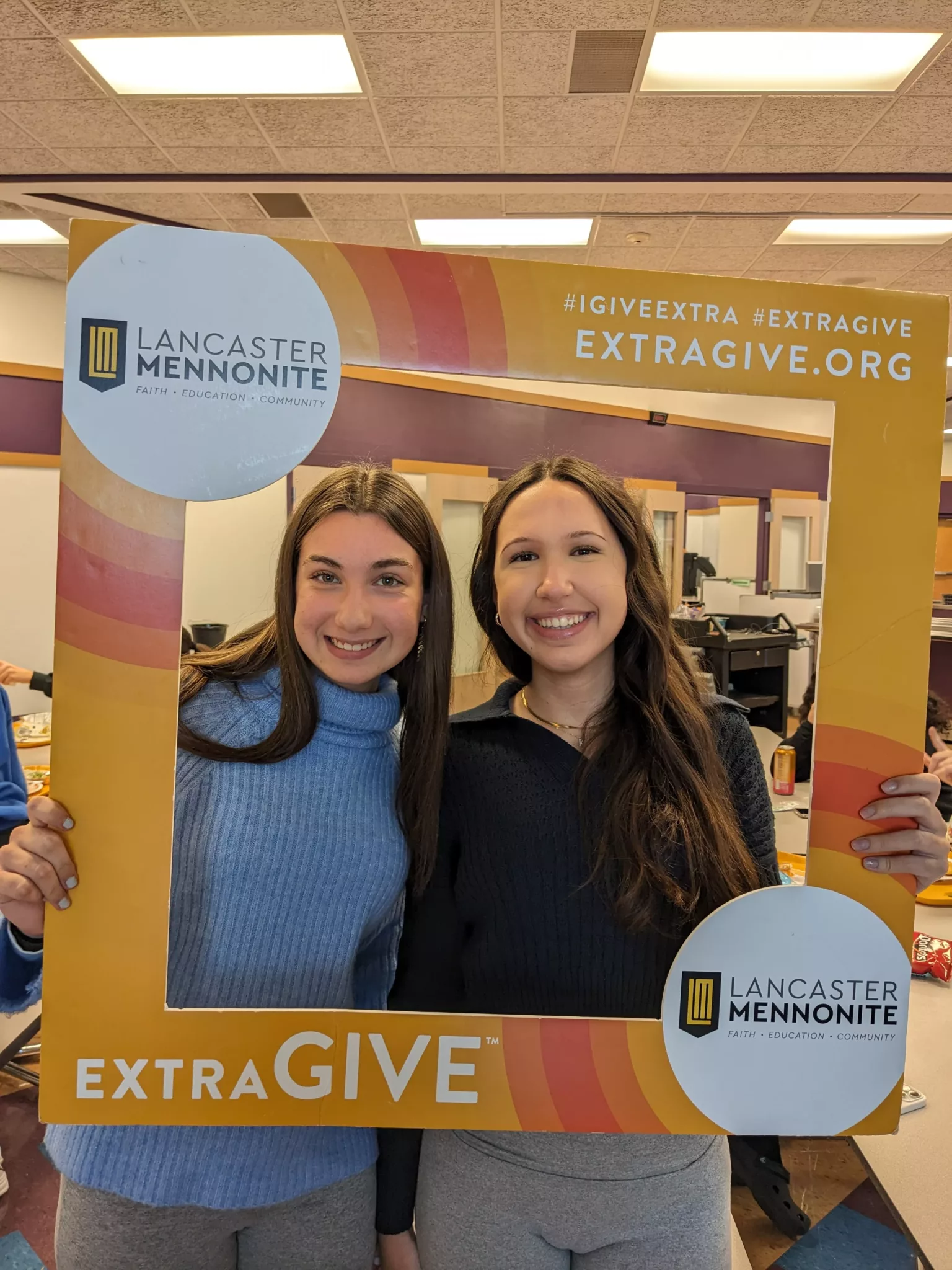 Students with ExtraGive sign