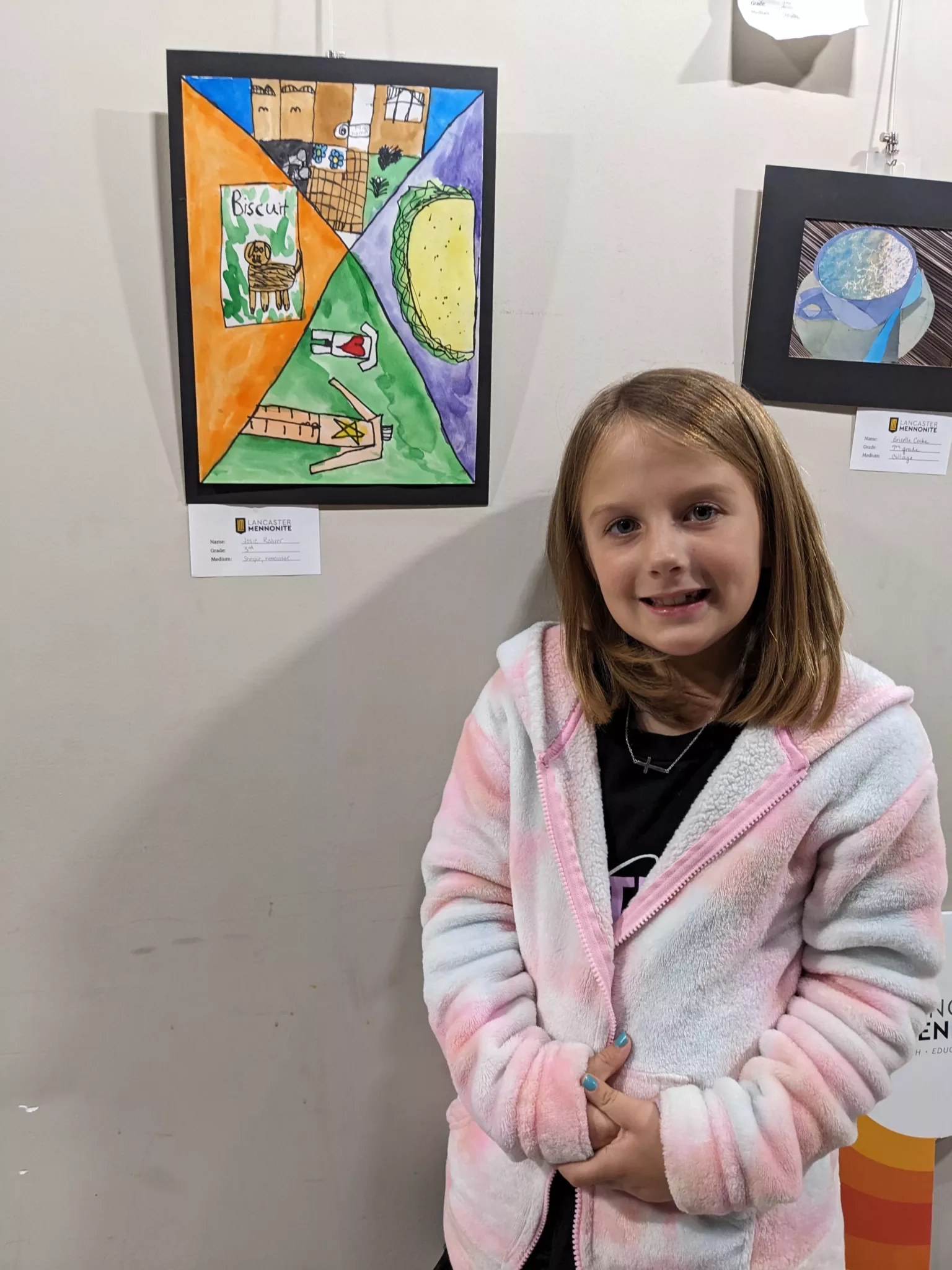 Student with her artwork on display