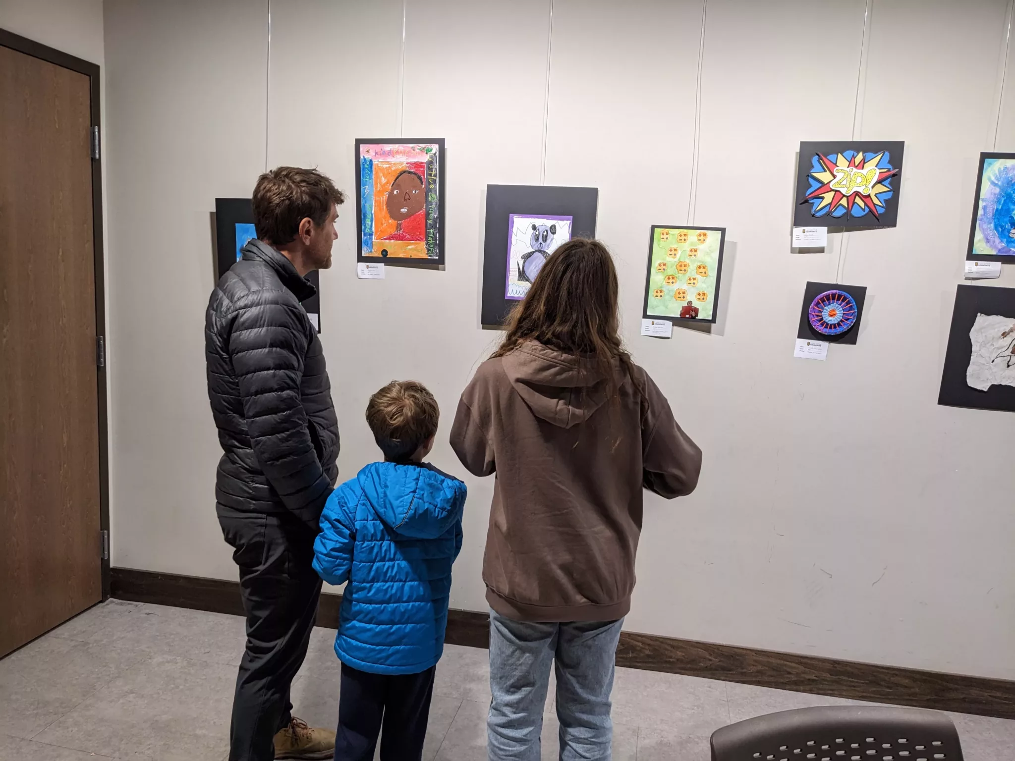 People looking at student artwork