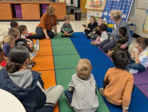 PreK classroom with students and teachers in circle time