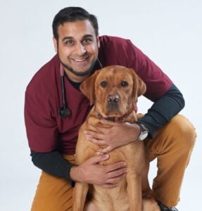 SANJAY, A VET WITH ONE OF HIS PATIENTS