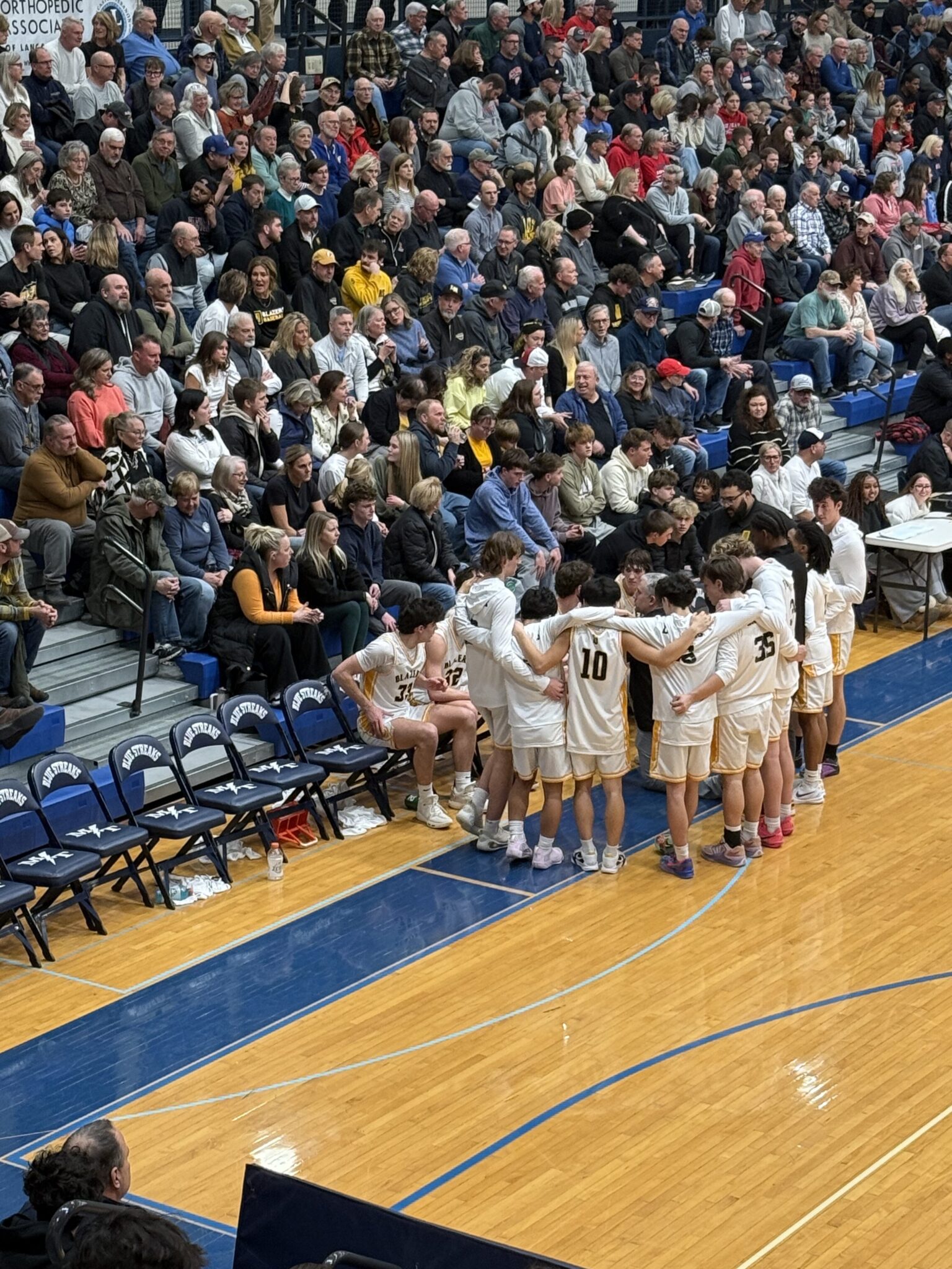LL League championship boys basketball game 2026 - Lancaster Mennonite team in huddle