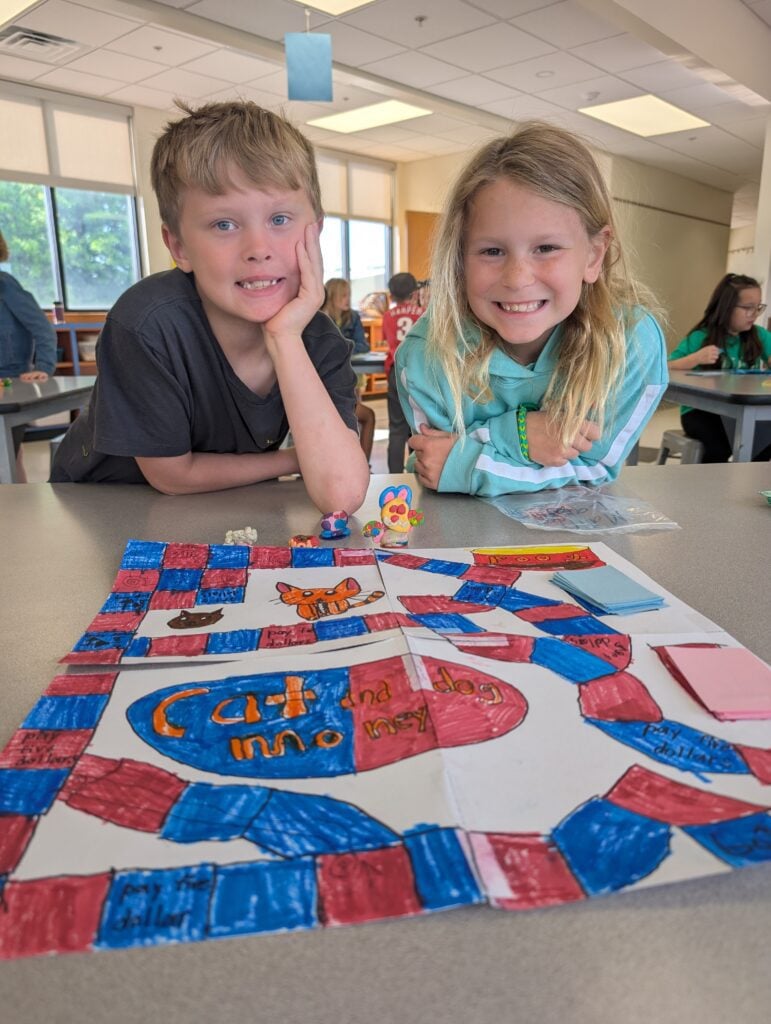 two LM students with a game they made