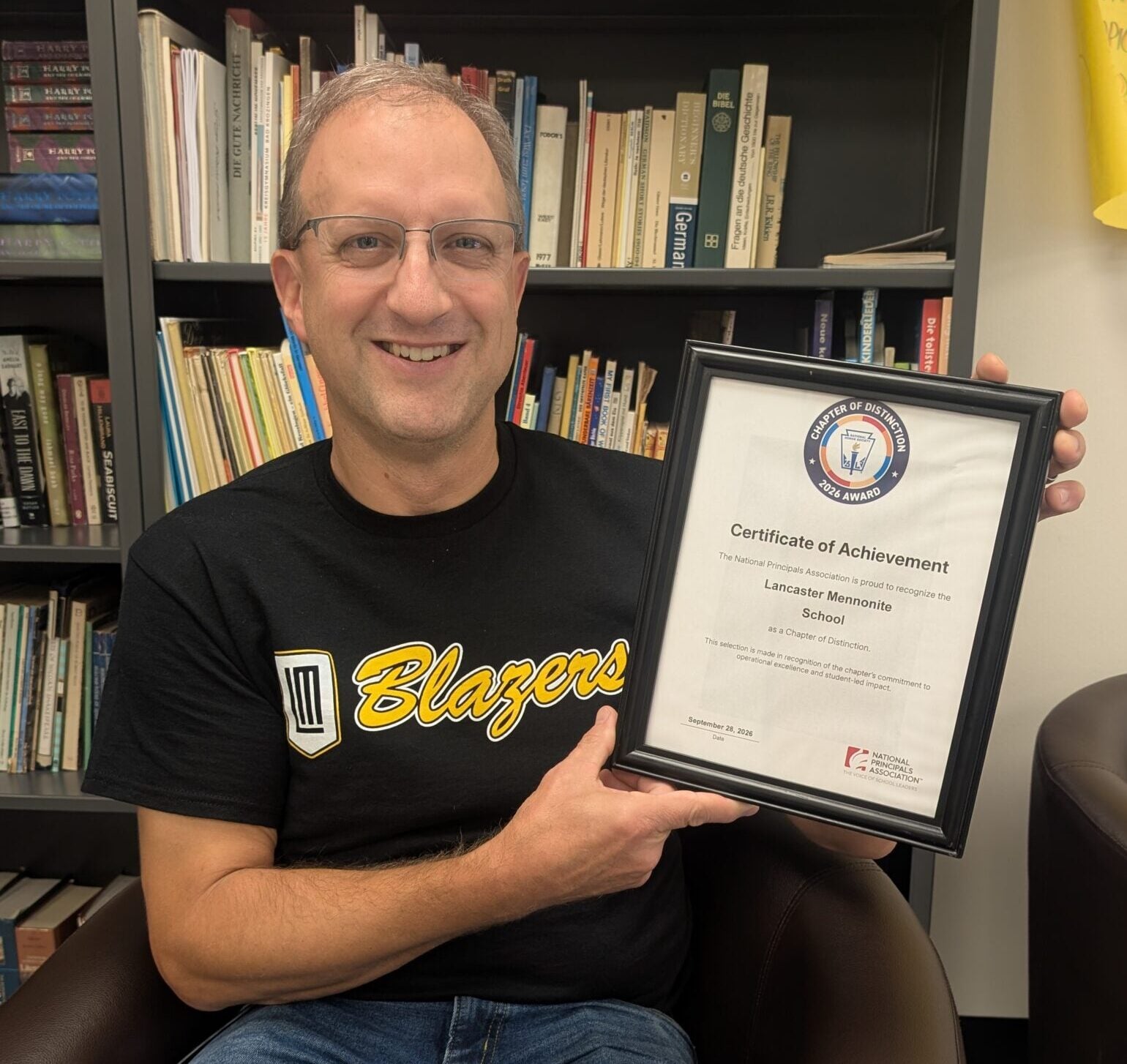 Mr. Metzler NHS Advisor holding the NHS award